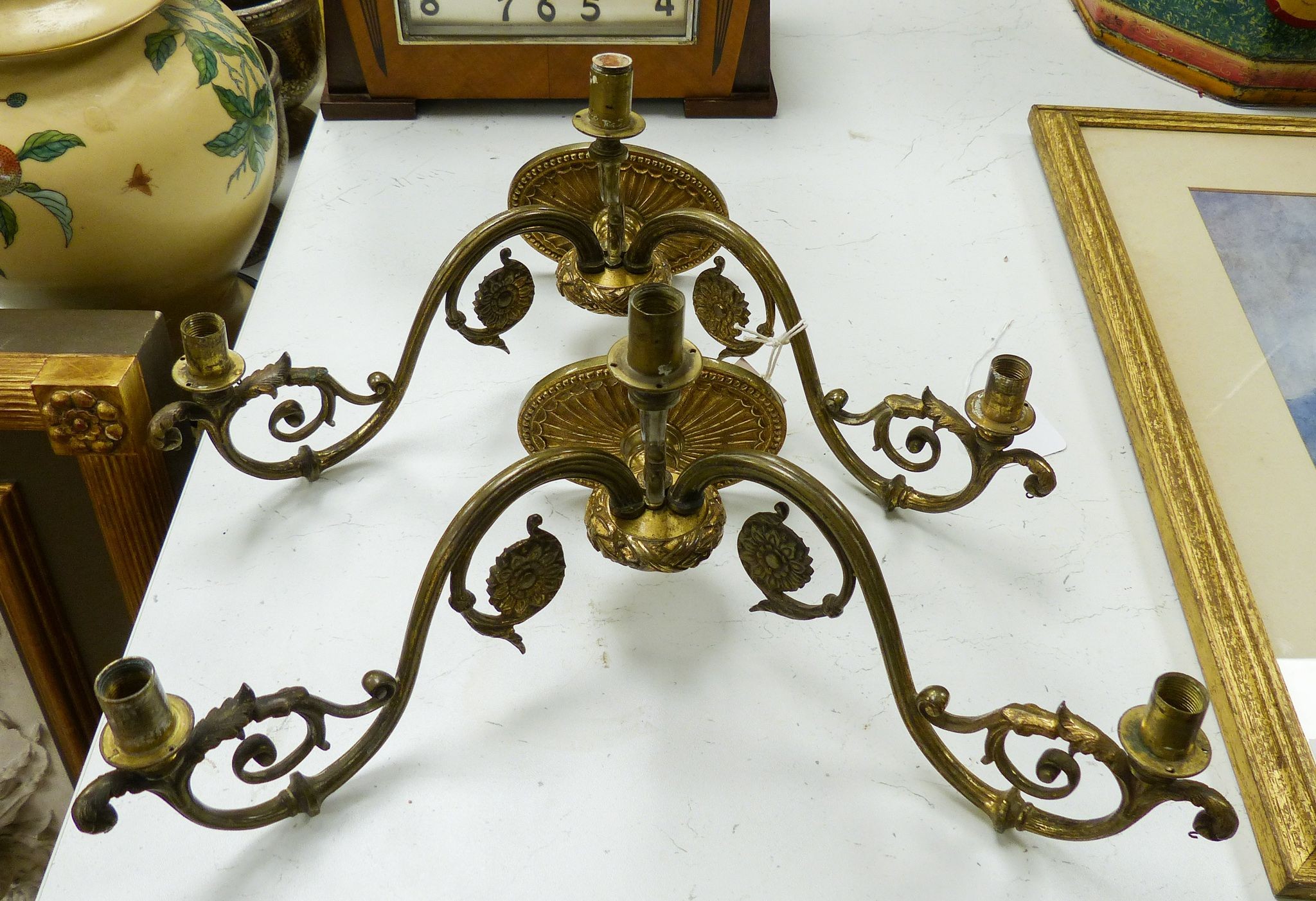 A pair of brass two-branch wall lights, 41 cm wide